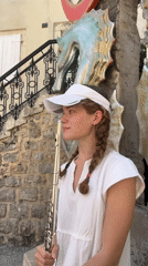 Tourist with flute explores historic Budva streets and marina