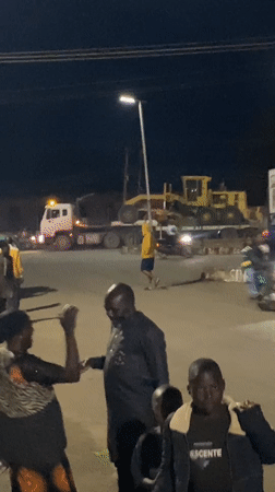 Nighttime street market activity in Bukuru, Nigeria