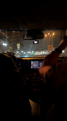 Nighttime car ride captured in Klin, passenger waves
