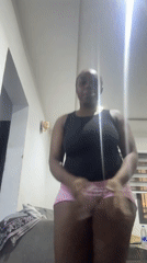 Woman dances energetically in Abuja living room during evening hours