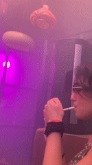 Woman smoking in colorful lit room in Tel Aviv