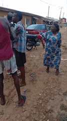 Group gathers on dirt road in Sabon Tasha, Nigeria