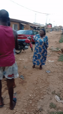 Group gathers on dirt road in Sabon Tasha, Nigeria