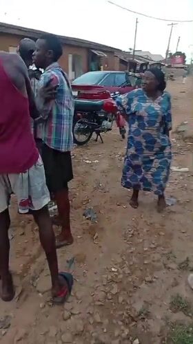 Group gathers on dirt road in Sabon Tasha, Nigeria