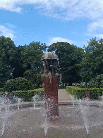 Tallinn park fountain with umbrella sculpture on a clear summer day