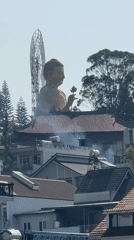 Morning routines documented near Buddha statue in Đà Lạt