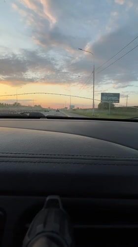 Vehicle travels Russian highway at sunset near Tugurgoy