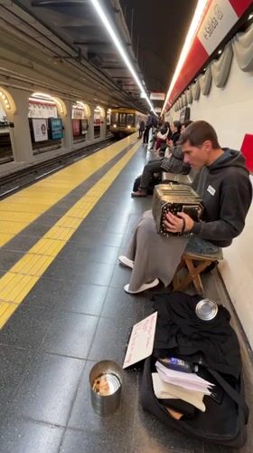Street musician plays bandoneon in Buenos Aires subway station