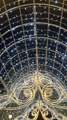 Minsk evening: lit archways, chandeliers, and a candlelit restaurant