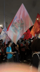 Flag-carrying demonstrators march through São Paulo streets blocking traffic