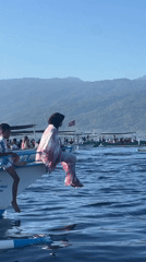 Woman and child aboard dolphin tour boat in Lovina