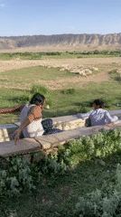 Men play in irrigation canal in rural Pakistan