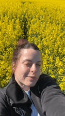 Woman films selfie videos in German flower field