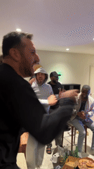 Men celebrate while watching soccer match in French living room