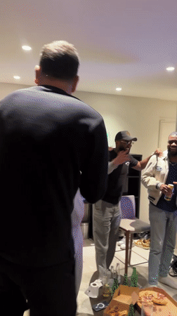 Men celebrate while watching soccer match in French living room