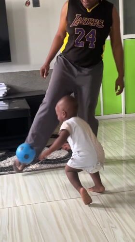 Toddler plays with balls in Nigerian living room