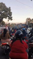 Bumper-to-bumper motorcycle traffic on an East Java road