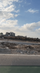 Road-level views through a damaged area near Gaza