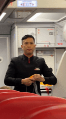 AirAsia flight attendant conducts safety demonstration in Kuta