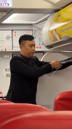 AirAsia flight attendant conducts safety demonstration in Kuta