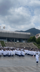 White-coated group gathers outside Chongqing canteen building