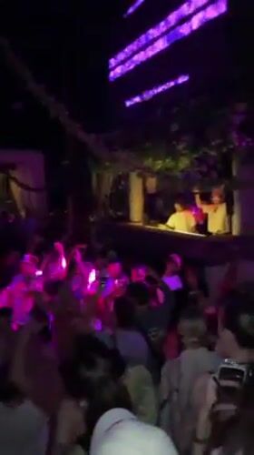 Nighttime party crowds gather at Bali cliff venues