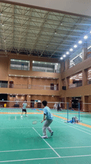 Indoor badminton game observed in Chongqing gymnasium