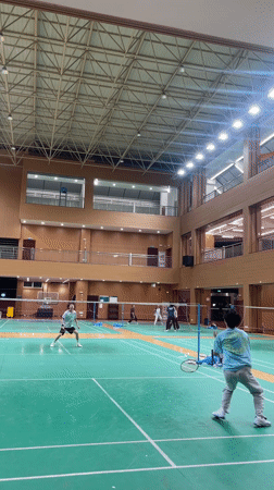 Indoor badminton game observed in Chongqing gymnasium