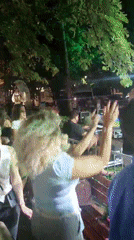 Live outdoor concert in Podgorica, crowd dancing under stage lights