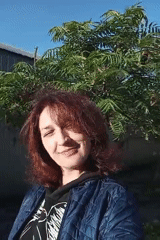 Woman photographed smiling outdoors in Rivne, Ukraine