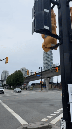 SkyTrain passes over Lougheed Town Centre on a cloudy evening