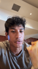 Young man records himself eating burrito meal in LA restaurant