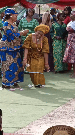 Women dance at outdoor celebration in Sabon Gari West