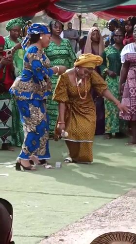 Women dance at outdoor celebration in Sabon Gari West