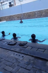 Kids fill a sunny Malang pool on a September morning