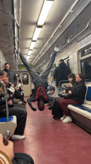 Spider-Man costumed performer does subway acrobatics in Russian train