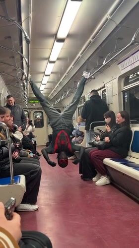 Spider-Man costumed performer does subway acrobatics in Russian train