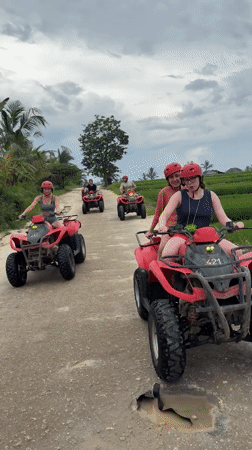 Red-helmeted riders on numbered ATVs traverse Payangan dirt roads