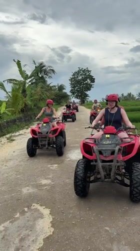 Red-helmeted riders on numbered ATVs traverse Payangan dirt roads