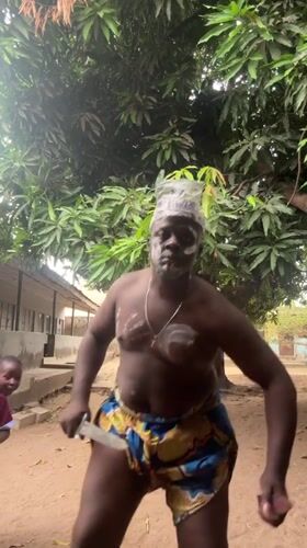 Traditional face paint observed on two men in Minna