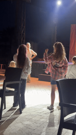 Dance instructor teaches four girls on illuminated stage in Turkey
