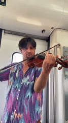 Violinist performs aboard train in Sant Boi de Llobregat