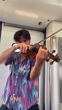 Violinist performs aboard train in Sant Boi de Llobregat