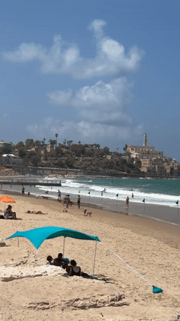 Surfers, swimmers, and beach life along the Tel Aviv coast