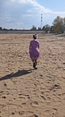 Woman performs beach yoga and dance in Noviy, Russia