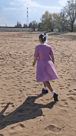 Woman performs beach yoga and dance in Noviy, Russia