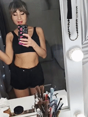 Woman takes mirror selfie during makeup routine in Chaikovsky