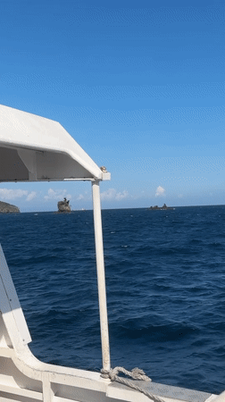 Open sea view with distant green islands off Indonesia