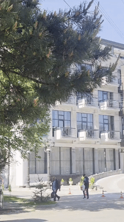 Morning pedestrian activity captured near residential building in Gyumri