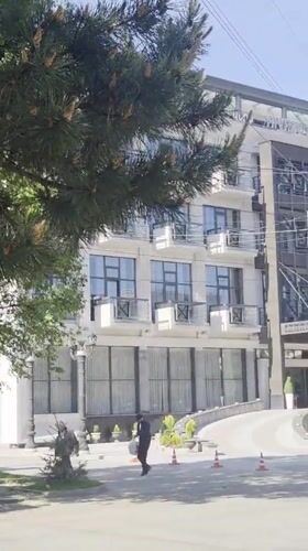 Morning pedestrian activity captured near residential building in Gyumri